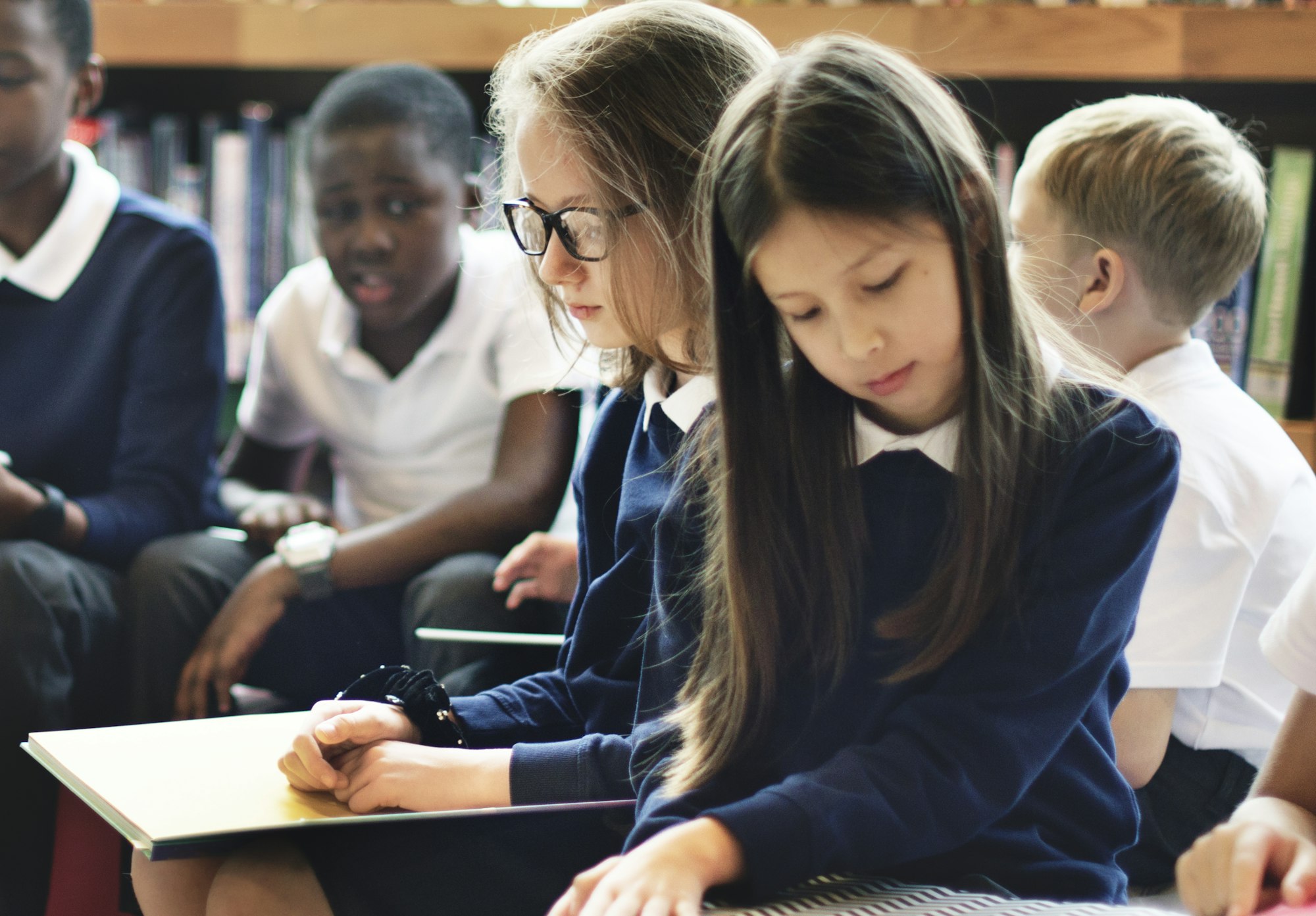 Diverse students wearing uniforms in school